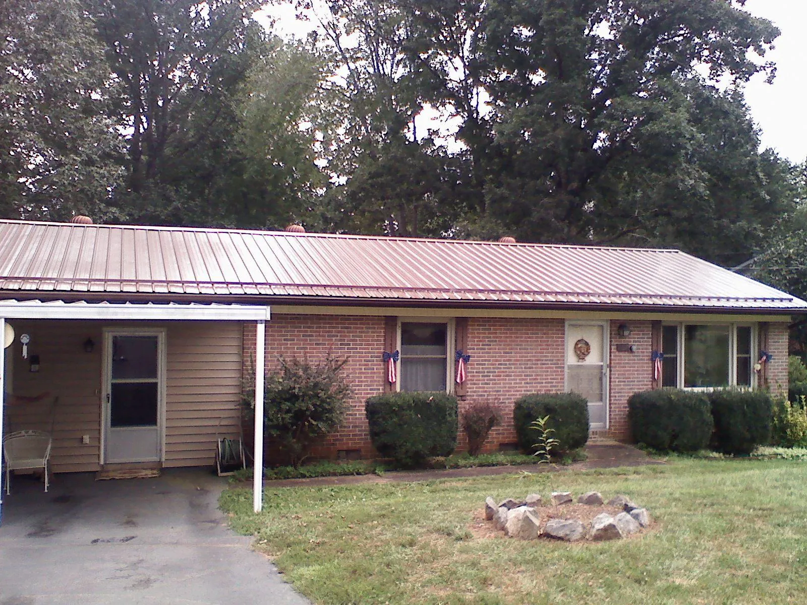 Bronze metal roof and carport on a brick ranch home — Roof Repair work by our crew in Shiloh